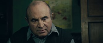 Movie still from “Beyond the Sea” (2004), directed by Kevin Spacey – An older man with a bald head looking at the camera; Close Up shot, Over the shoulder angle