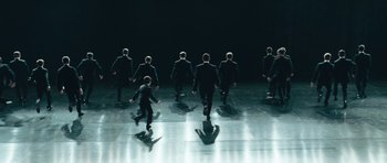Movie still from “Beyond the Sea” (2004), directed by Kevin Spacey – A group of men in black suits on a stage; Wide shot, High angle