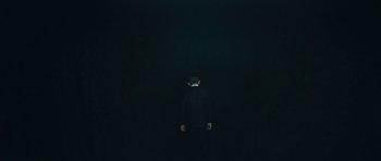 Movie still from “Beyond the Sea” (2004), directed by Kevin Spacey – A man in a suit standing in the dark; Wide shot, Low angle