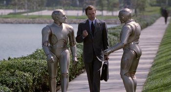 Movie still from “Bicentennial Man” (1999), directed by Chris Columbus – A man in a business suit walking down a sidewalk; Medium shot, High angle