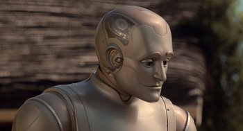 Movie still from “Bicentennial Man” (1999), directed by Chris Columbus – An image of a robot that is looking at something; Close Up shot, High angle