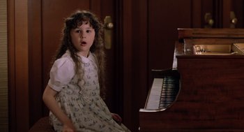 Movie still from “Bicentennial Man” (1999), directed by Chris Columbus – A little girl sitting in front of a piano; Close Up shot, High angle