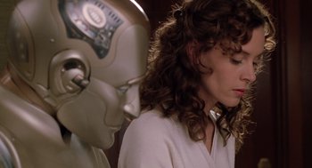 Movie still from “Bicentennial Man” (1999), directed by Chris Columbus – A woman standing in front of a robot head; Close Up shot, Over the shoulder angle