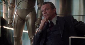 Movie still from “Bicentennial Man” (1999), directed by Chris Columbus – A man in a suit and tie; Medium shot, Low angle