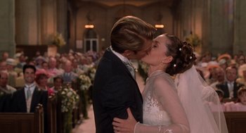 Movie still from “Bicentennial Man” (1999), directed by Chris Columbus – A man and a woman kissing in front of a crowd of people; Close Up shot, Over the shoulder angle