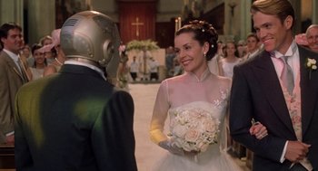 Movie still from “Bicentennial Man” (1999), directed by Chris Columbus – A woman in a wedding dress holding a bouquet of flowers; Close Up shot, Over the shoulder angle
