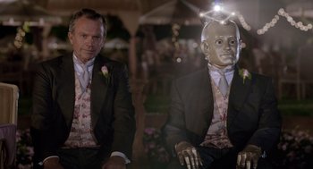 Movie still from “Bicentennial Man” (1999), directed by Chris Columbus – Two men in suits and ties standing next to each other; Close Up shot, Over the shoulder angle