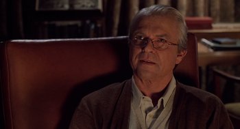 Movie still from “Bicentennial Man” (1999), directed by Chris Columbus – An older man sitting in a leather chair; Close Up shot, Over the shoulder angle