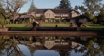 Movie still from “Bicentennial Man” (1999), directed by Chris Columbus – A house with a reflection in the water; Extreme Wide shot, High angle