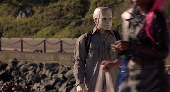 Movie still from “Bicentennial Man” (1999), directed by Chris Columbus – A statue of a man with a helmet on; Medium shot, Over the shoulder angle