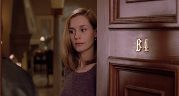 Movie still from “Bicentennial Man” (1999), directed by Chris Columbus – A woman standing in front of a wooden door; Close Up shot, Over the shoulder angle