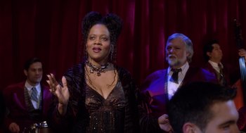 Movie still from “Bicentennial Man” (1999), directed by Chris Columbus – A man and a woman are standing in front of a curtain; Medium shot, Over the shoulder angle