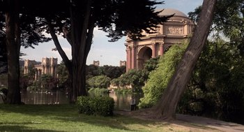 Movie still from “Bicentennial Man” (1999), directed by Chris Columbus – A person standing next to a tree near a body of water; Extreme Wide shot, High angle