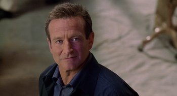 Movie still from “Bicentennial Man” (1999), directed by Chris Columbus – A person wearing a shirt and jacket; Close Up shot, Over the shoulder angle