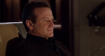 Movie still from “Bicentennial Man” (1999), directed by Chris Columbus – A person wearing a suit and tie; Close Up shot, Over the shoulder angle