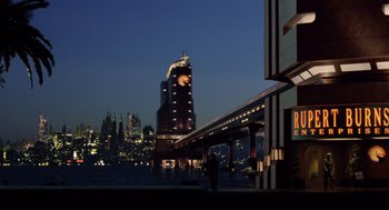 Movie still from “Bicentennial Man” (1999), directed by Chris Columbus – A person standing on a bridge near a body of water; Extreme Wide shot, High angle