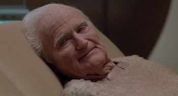 Movie still from “Bicentennial Man” (1999), directed by Chris Columbus – An older man laying in a bed with his eyes closed; Close Up shot, High angle