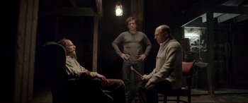 A group of men sitting in a dark room