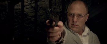 A man holding a gun pointed at the camera