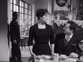 Movie still from “Big Deal on Madonna Street” (1958), directed by Mario Monicelli – A man and a woman sitting at a dinner table; Medium shot, Over the shoulder angle