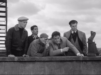 Movie still from “Big Deal on Madonna Street” (1958), directed by Mario Monicelli – A black and white photo of a group of men; Wide shot, Low angle