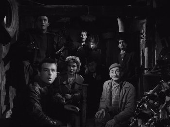 Movie still from “Big Deal on Madonna Street” (1958), directed by Mario Monicelli – A black and white photo of a group of people in a room; Wide shot, High angle