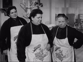 Movie still from “Big Deal on Madonna Street” (1958), directed by Mario Monicelli – A group of women wearing aprons standing next to each other; Medium shot, Low angle