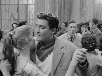 Movie still from “Big Deal on Madonna Street” (1958), directed by Mario Monicelli – A man and a woman dancing in front of a crowd; Medium shot, Low angle