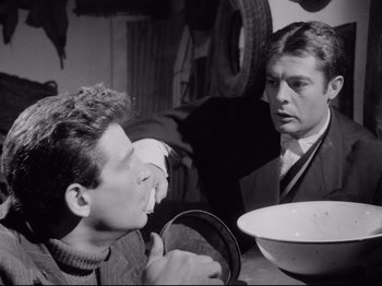 Movie still from “Big Deal on Madonna Street” (1958), directed by Mario Monicelli – Two men sitting at a table with a bowl in front of them; Medium shot, Over the shoulder angle