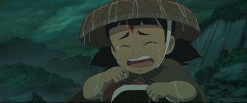 Movie still from “Big Fish & Begonia” (2016), directed by Chun Zhang – An asian child crying in the rain with his head hanging down; Close Up shot, High angle