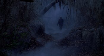 Movie still from “Big Fish” (2003), directed by Tim Burton – A man walking down a trail in the woods; Extreme Wide shot, High angle