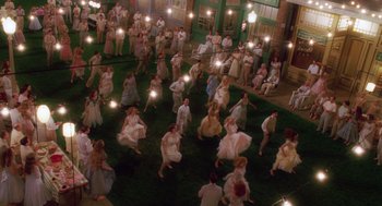 Movie still from “Big Fish” (2003), directed by Tim Burton – A group of people are dancing on the grass at night; Extreme Wide shot, High angle