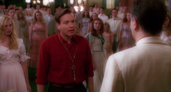 Movie still from “Big Fish” (2003), directed by Tim Burton – A group of people standing in front of a crowd; Medium shot, Over the shoulder angle