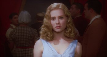 Movie still from “Big Fish” (2003), directed by Tim Burton – A woman with blonde curly hair wearing a blue dress; Close Up shot, Over the shoulder angle