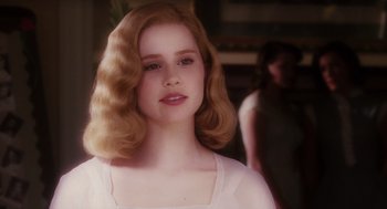 Movie still from “Big Fish” (2003), directed by Tim Burton – A young girl with blonde curly hair and a white dress; Close Up shot, Over the shoulder angle