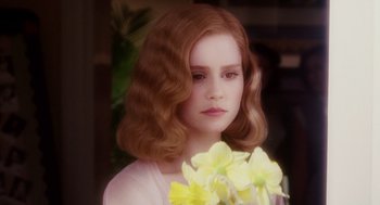 Movie still from “Big Fish” (2003), directed by Tim Burton – A young girl with red hair holding a bouquet of flowers; Close Up shot, Over the shoulder angle
