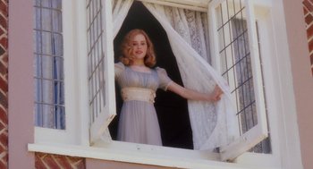 Movie still from “Big Fish” (2003), directed by Tim Burton – A young woman in a dress standing at a window; Medium shot, Low angle
