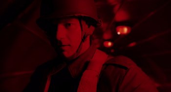 Movie still from “Big Fish” (2003), directed by Tim Burton – A man wearing a helmet is standing in a dark room; Close Up shot, Low angle