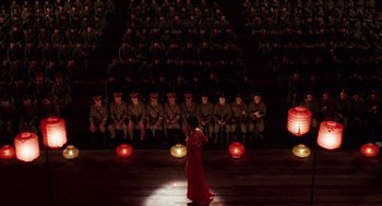 Movie still from “Big Fish” (2003), directed by Tim Burton – A woman in a red dress standing in front of a group of soldiers; Extreme Wide shot, High angle