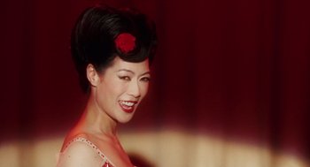 Movie still from “Big Fish” (2003), directed by Tim Burton – A woman with a red rose in her hair; Close Up shot, Over the shoulder angle