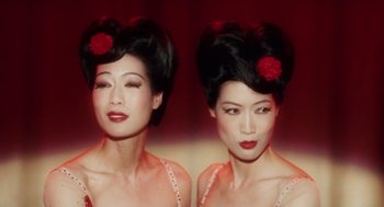 Movie still from “Big Fish” (2003), directed by Tim Burton – A woman with a red flower in her hair; Close Up shot, High angle