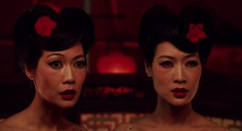Two asian women with red lipstick and black hair