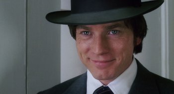 Movie still from “Big Fish” (2003), directed by Tim Burton – A person wearing a suit and a hat; Close Up shot, Over the shoulder angle