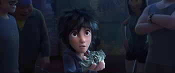 Movie still from “Big Hero 6” (2014), directed by Chris Williams – A young boy holding a bunch of money in his hand; Close Up shot, Over the shoulder angle