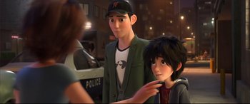 Movie still from “Big Hero 6” (2014), directed by Chris Williams – A man and a boy standing next to each other in front of a police car; Medium shot, Over the shoulder angle