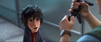 Movie still from “Big Hero 6” (2014), directed by Chris Williams – A person is drawing a picture of another person; Close Up shot, High angle