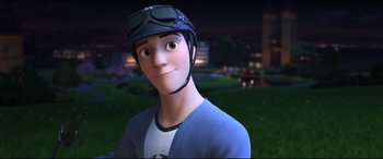Movie still from “Big Hero 6” (2014), directed by Chris Williams – A man with a helmet on his head is smiling; Close Up shot, Over the shoulder angle