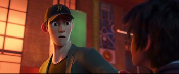 Movie still from “Big Hero 6” (2014), directed by Chris Williams – A man with a baseball cap is looking at the camera; Close Up shot, Over the shoulder angle