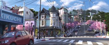 Movie still from “Big Hero 6” (2014), directed by Chris Williams – A street scene with a person riding a bike; Extreme Wide shot, High angle