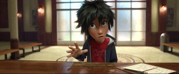 Movie still from “Big Hero 6” (2014), directed by Chris Williams – A boy with black hair is sitting at a table; Close Up shot, High angle